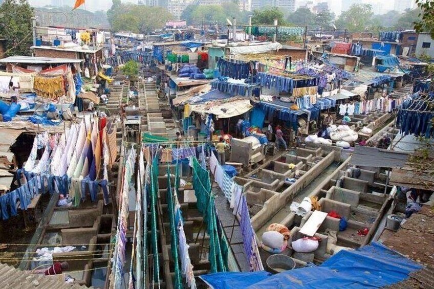A densely packed market with numerous stalls selling textiles and fabrics. 4