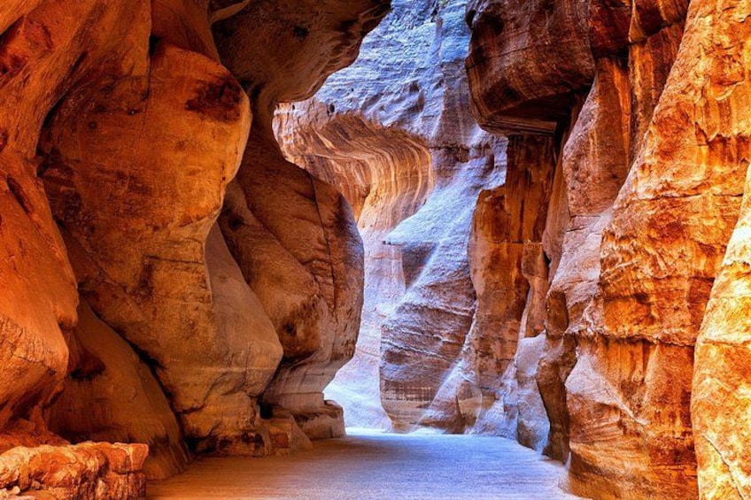 A narrow canyon with layered rock formations. 2