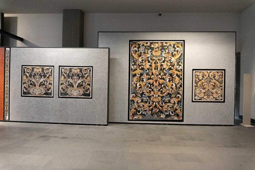 A gallery with three framed artworks on the wall. 4