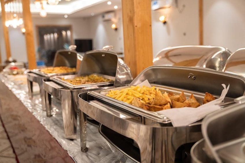 Buffet-style food service with multiple serving stations. 2