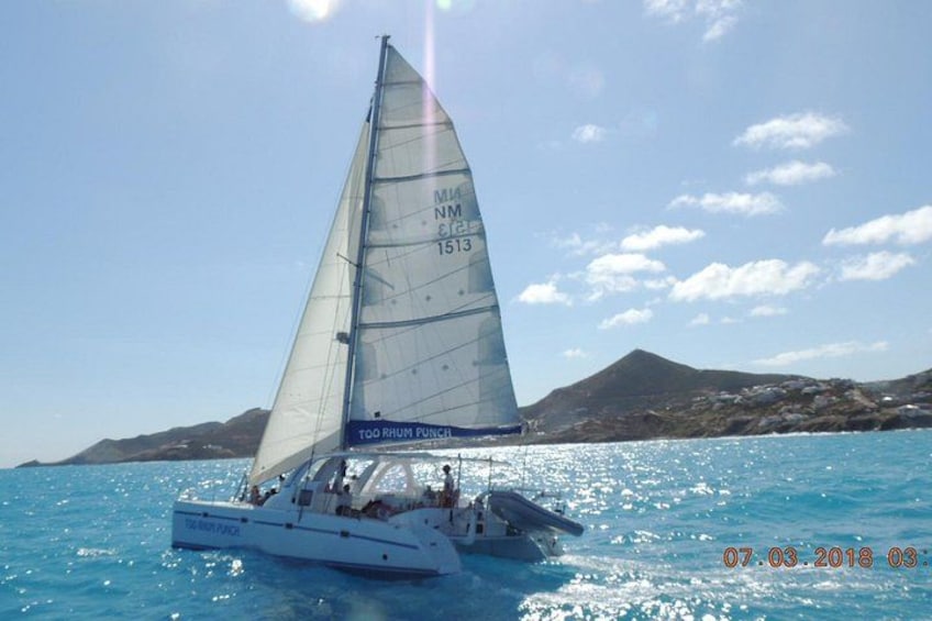 A sailboat named 'TOORUM PUNCH' with the registration number NM 1513 sailing on turquoise waters. 3