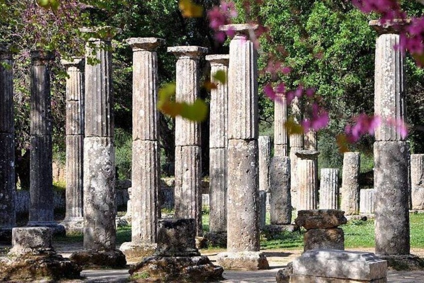 Ancient stone columns in a garden setting. 1