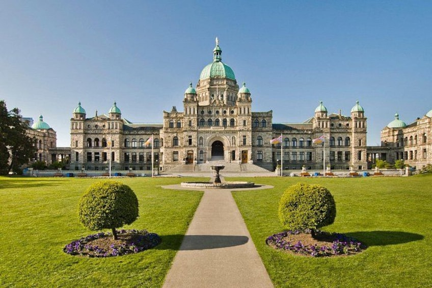 A grand building with a central dome, surrounded by well-manicured lawns and symmetrical landscaping. 3