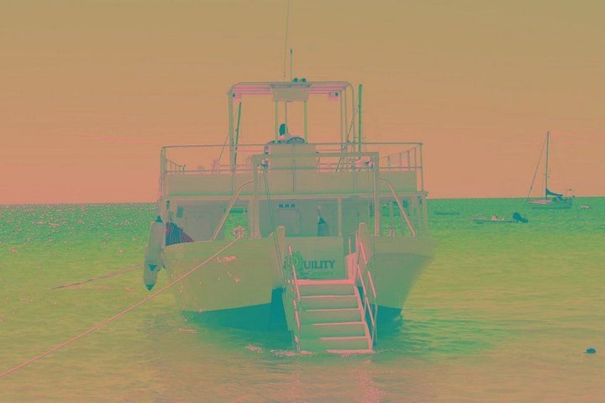 A boat named 'FAMILY' on calm water with a clear sky. 4