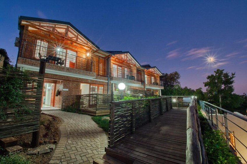 A modern two-story house with a wooden deck and a brick facade. 2