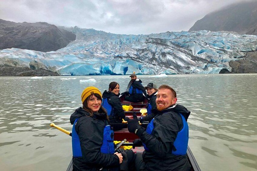 A group of people in a boat on a glacier. 2