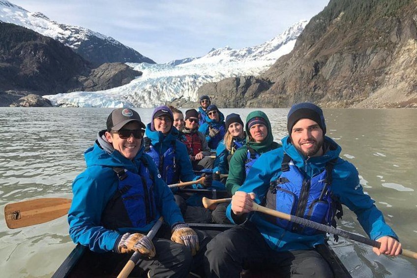 A group of people in a boat on a glacier. 5