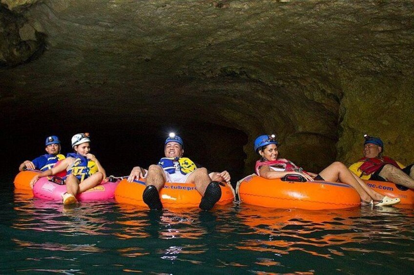 People in inflatable tubes in a cave. 1