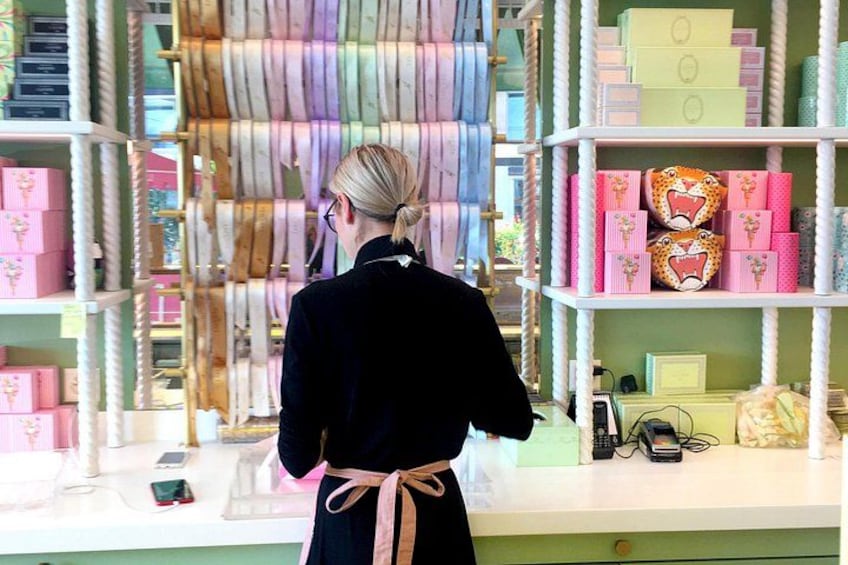 A person browsing through a store with shelves of colorful boxes and items. 4