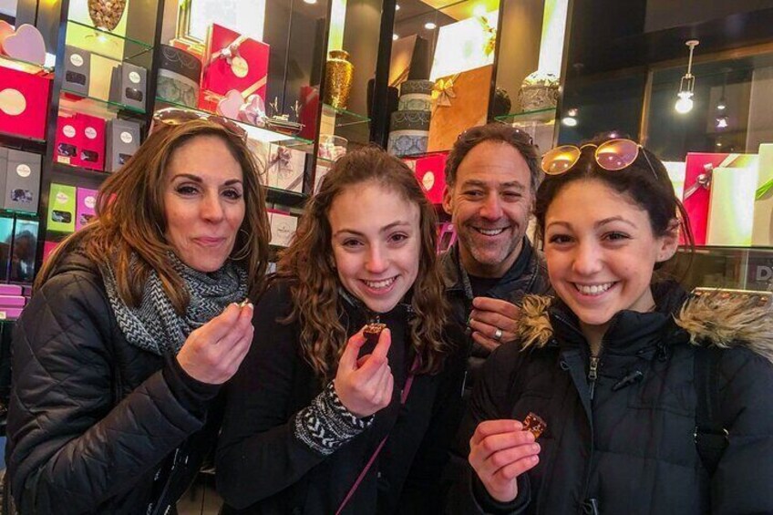 Four people in a store with gift boxes. 4
