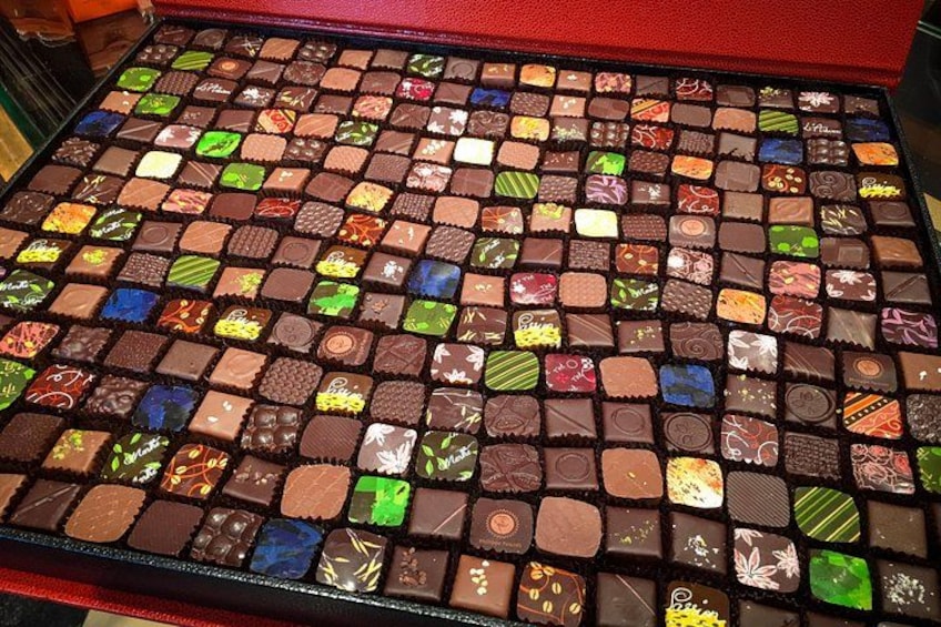 Geneva chocolate tour highlight: gourmet chocolate box featuring artisan designs and vibrant flavor variety 3