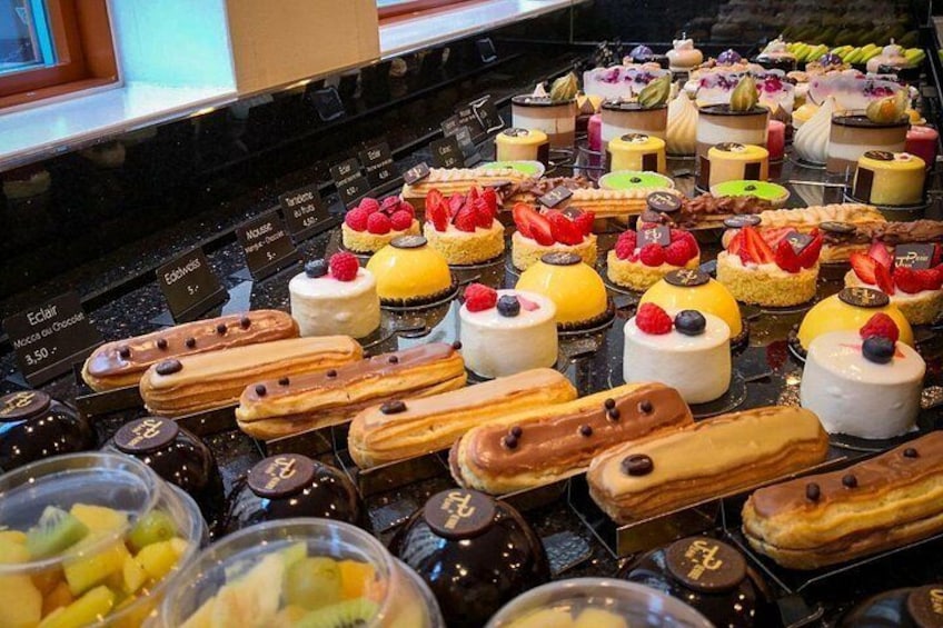 Geneva chocolate tour highlight: gourmet patisserie display featuring artisan mousses, éclairs, and fruit-topped creations 5