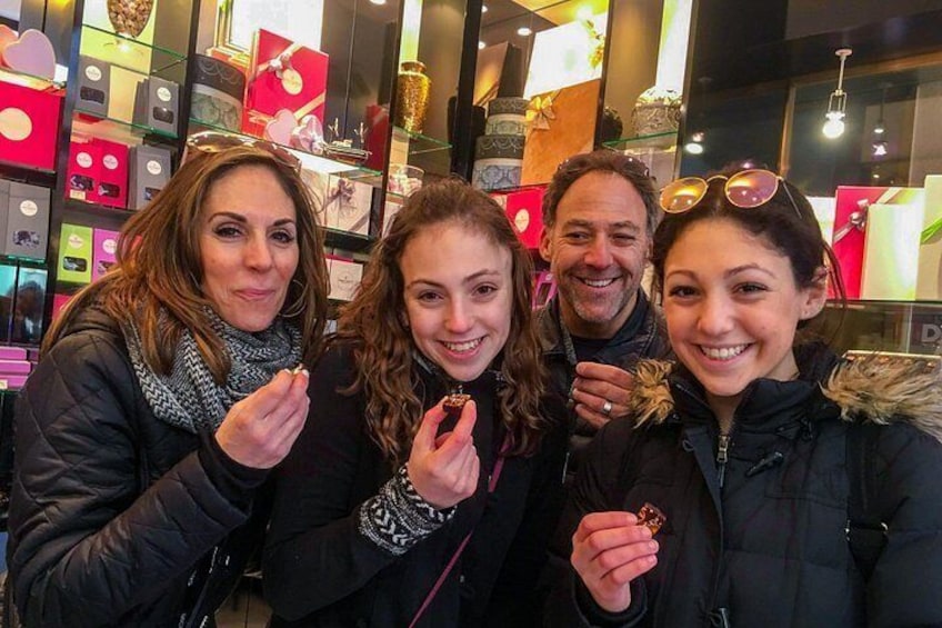 Geneva chocolate tour highlight: family enjoying artisan treats in a cozy boutique setting 5