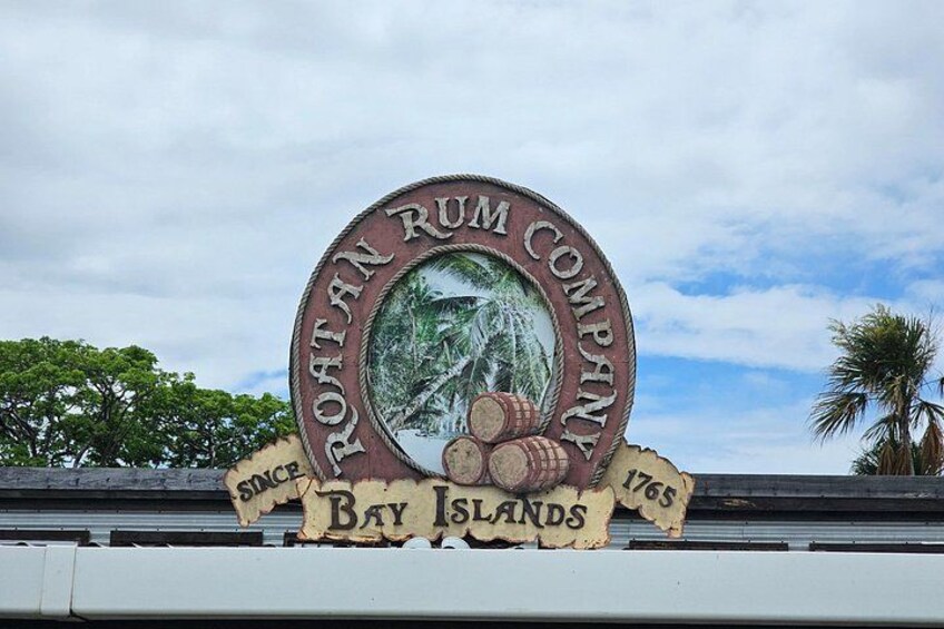 A sign with the text 'Roatan Rum Company' and 'Bay Islands 1765'. 4