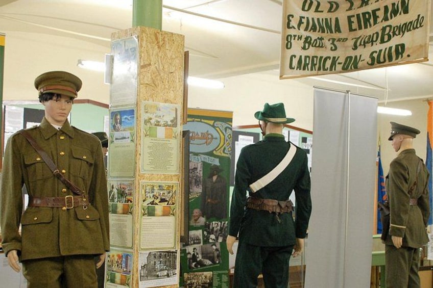 Mannequins in military uniforms, a wooden display board with historical information, and a sign about the 8th Battalion. 2