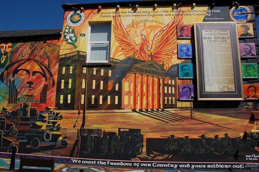 A mural with a phoenix, a building, and a sign with portraits. 4