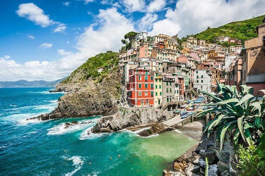Une ville côtière aux bâtiments aux couleurs vives, aux falaises rocheuses et aux eaux turquoise. 3