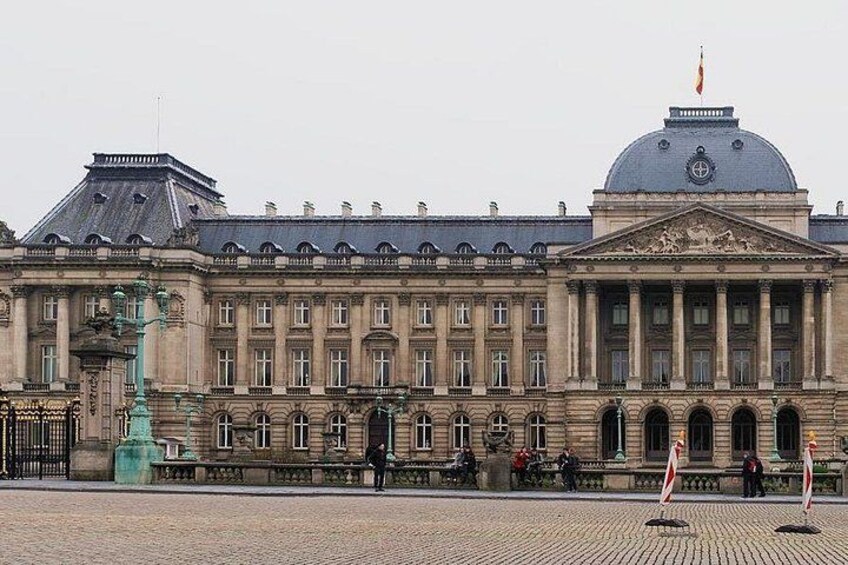A large historic building with a dome and columns, a fountain, and a cobblestone plaza. 1