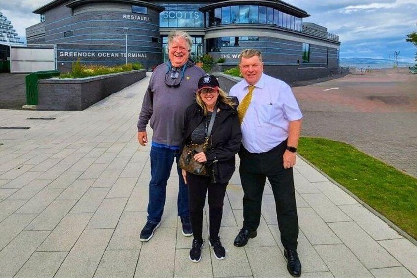 Three people standing in front of a building with signage for 'Greenock Ocean Terminal' and 'The Way.' 4
