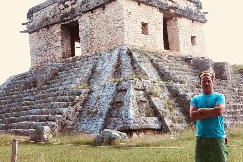 A stone pyramid structure with a staircase leading up to a building. 2
