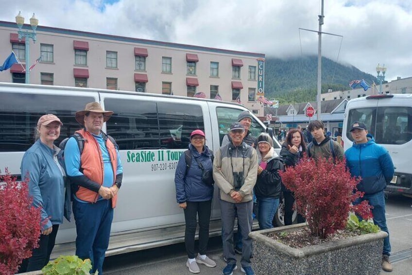 A group of people standing in front of a tour bus with 'SeaSide II Tours' written on it. 5