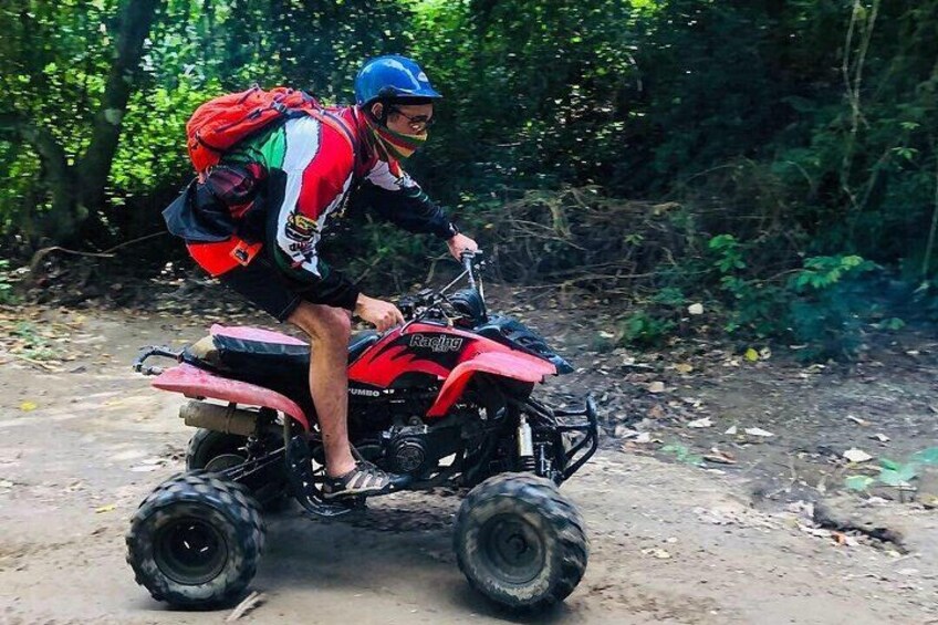 Dune buggies splash through a shallow jungle creek, kicking up water as passengers laugh. Lush greenery and hanging vines frame the action-packed moment. 5