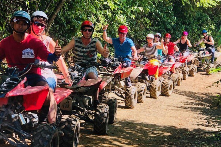 A group of people riding atv's on a dirt path. 4