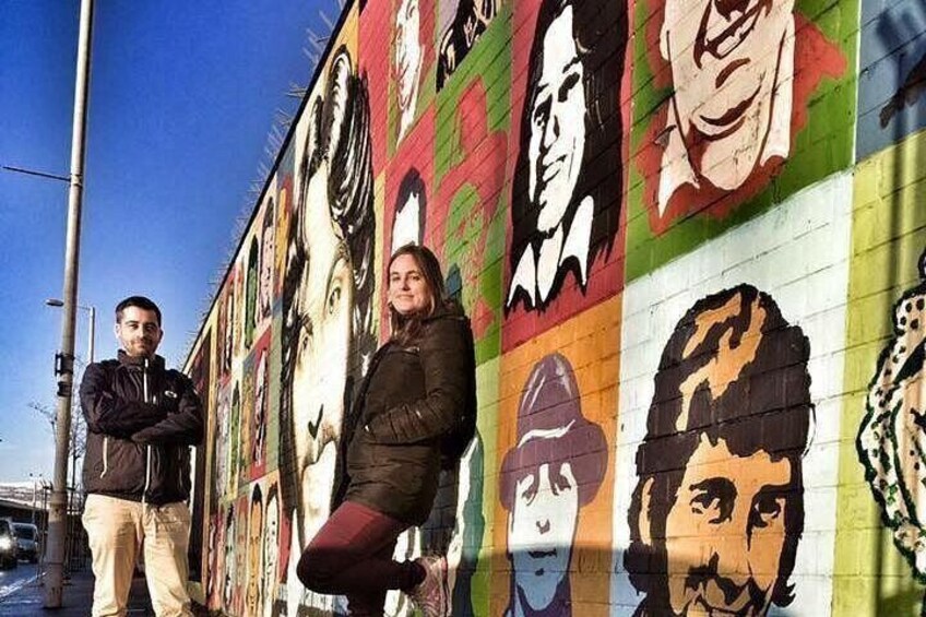 A mural with multiple portraits on a wall. 2