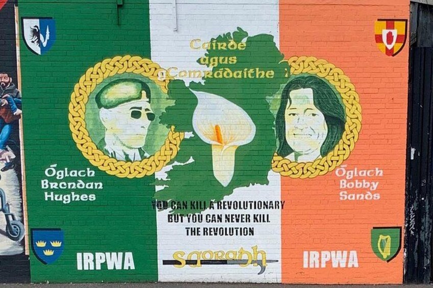 A mural with portraits and text, including 'Oglach Bobby Sands' and 'IRPWA' on a wall. 2