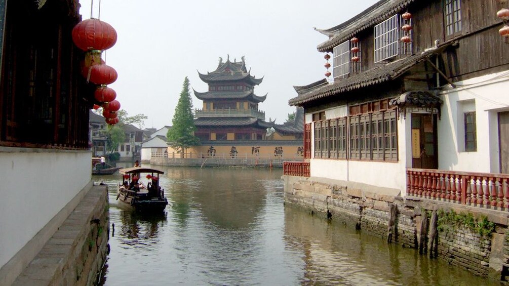 Serene view of a water boat floating on the water at the Zhujiajiao Water Village in Shanghai 