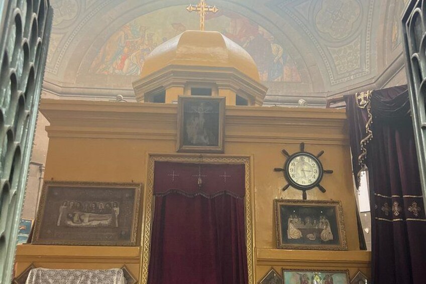 An ornate interior with a large clock, a red door, and a ceiling fresco. 2