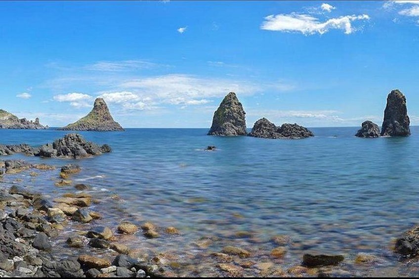 A coastal landscape with rocky formations and calm waters. 5