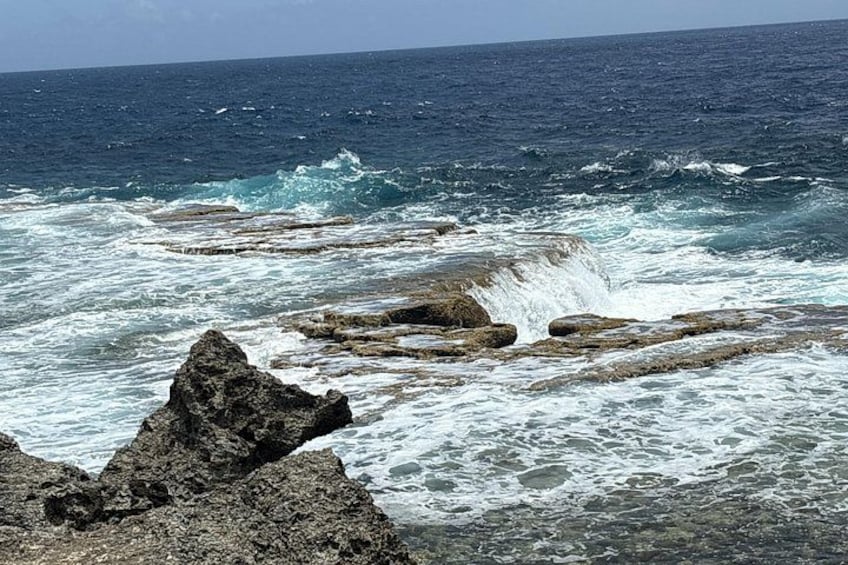 A rocky coastline with waves crashing against the rocks. 5
