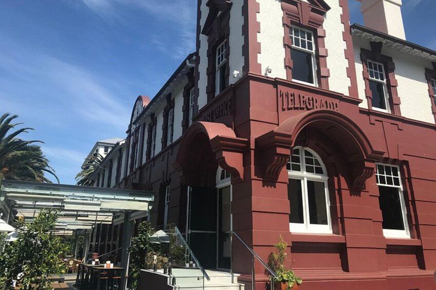 A red building with the sign 'TELEGRAPE' and a staircase leading to the entrance. 4