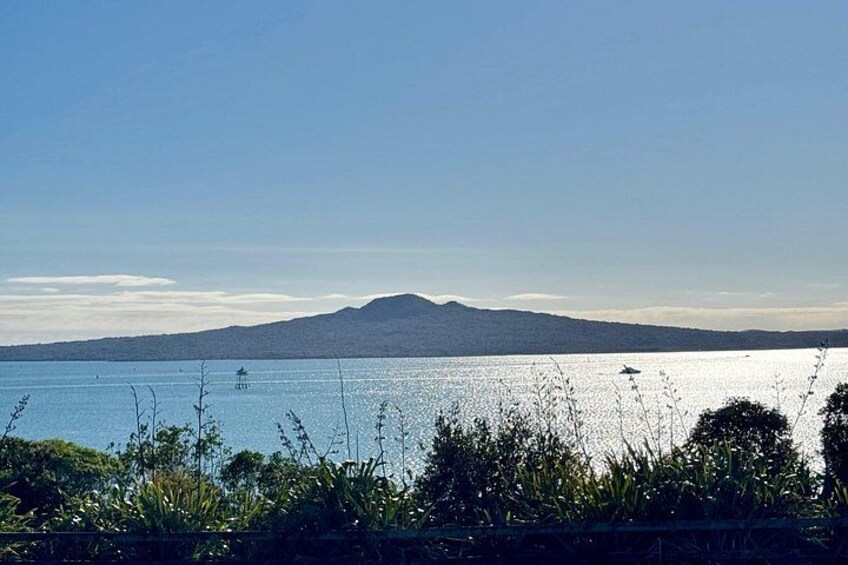 A calm lake with a mountain in the background, surrounded by greenery. 1