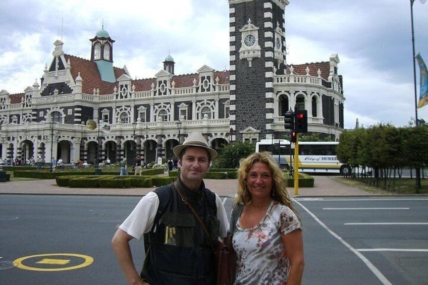 Your guide, Athol, with a customer in front of Dunedin Railway Station, on one of his first ever tours (circa 2006) 5