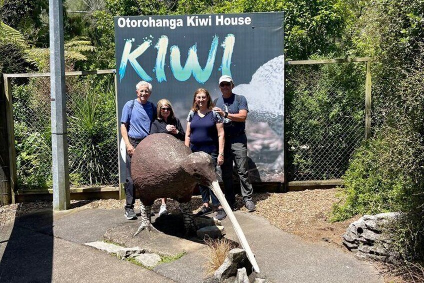 A sign for Otorohanga Kiwi House with a kiwi and a person holding a kiwi. 3