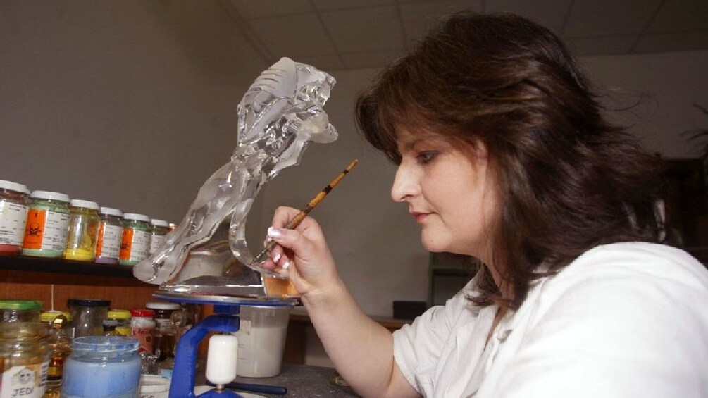 Nizbor Glass Facotry employee adding details by hand to blown glass in Prague