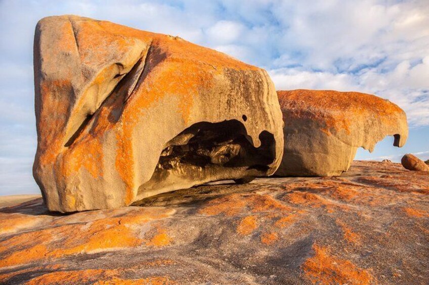 A large rock formation with a cave-like opening. 4