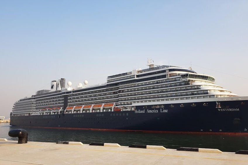 A large cruise ship docked at a port. 1