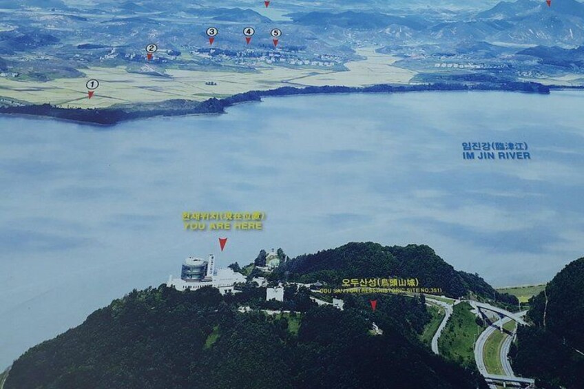 A river, a bridge, and a mountainous area with a building. 4