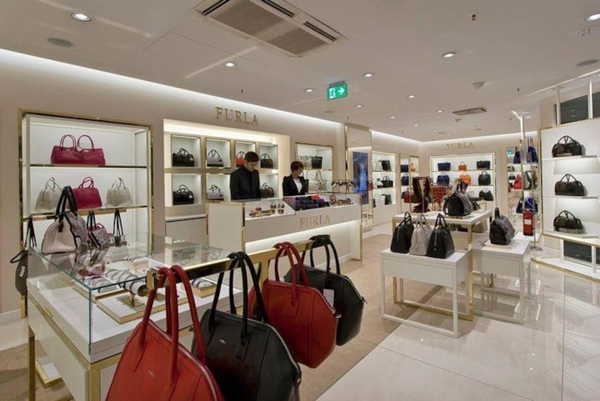 A FURLA store interior with handbags on display. 2