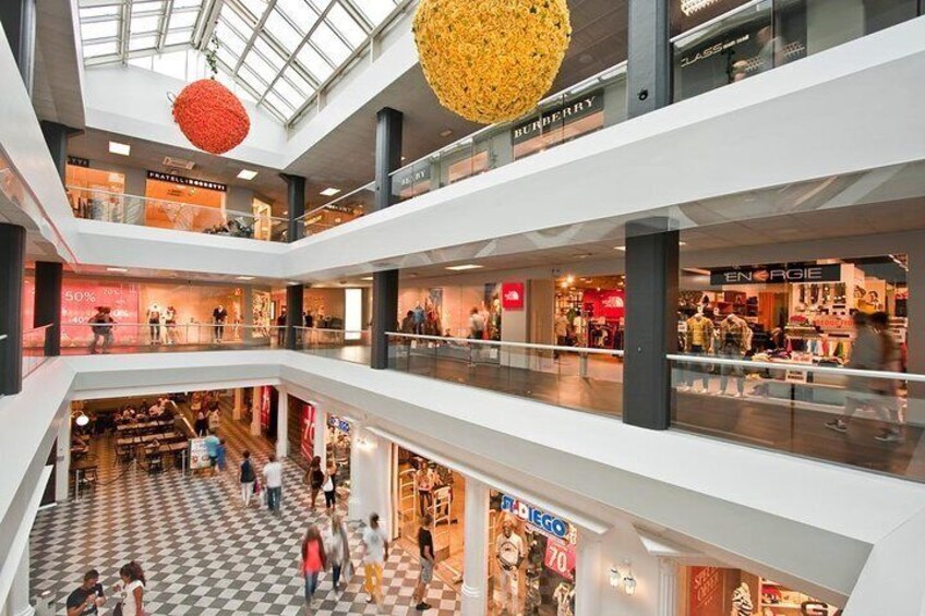 A multi-level shopping mall with various stores, including a visible 'BUNNERY' and 'ENERGIE' store. 5