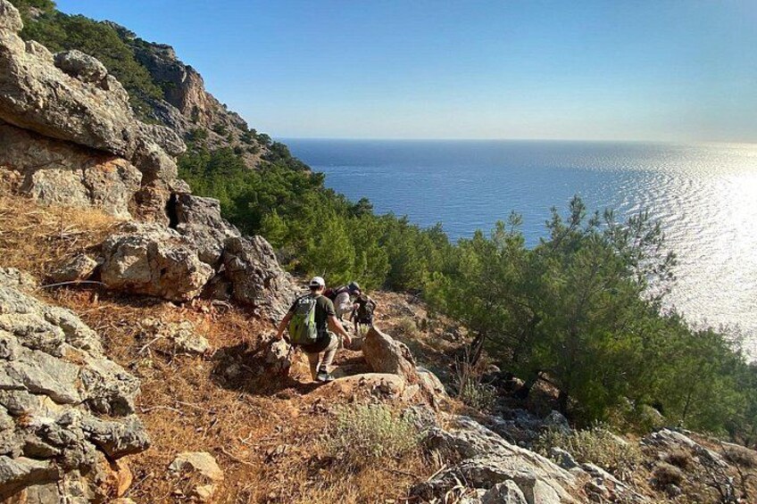 A rocky hiking trail with a view of the sea. 2