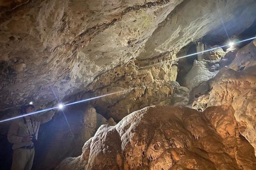 A cave interior with stalactites and stalagmites. 4