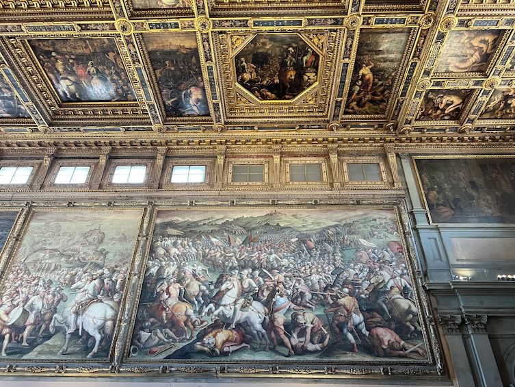 A grand ceiling with intricate frescoes and ornate gold detailing. 4
