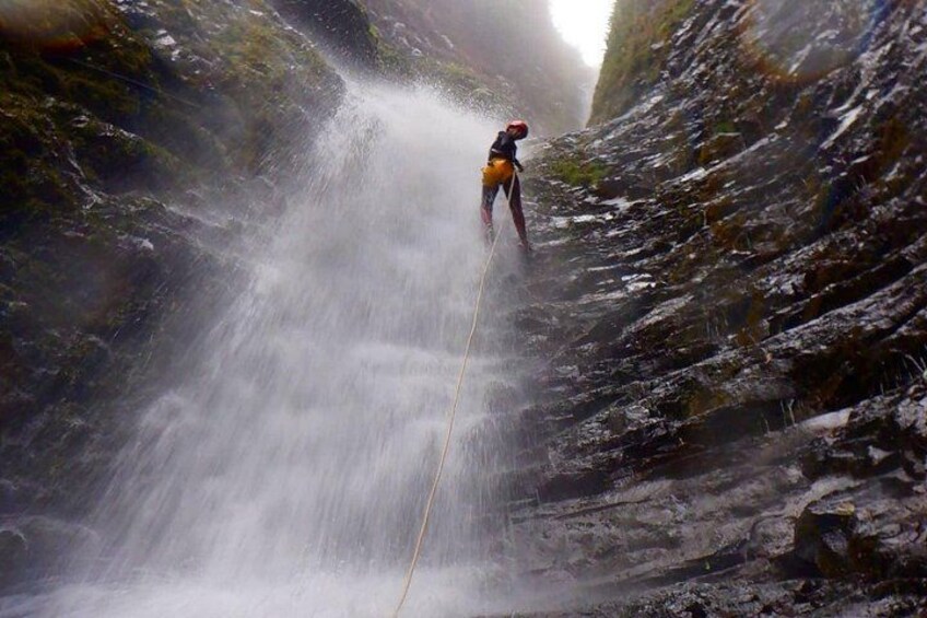 A person rappelling down a waterfall. 3