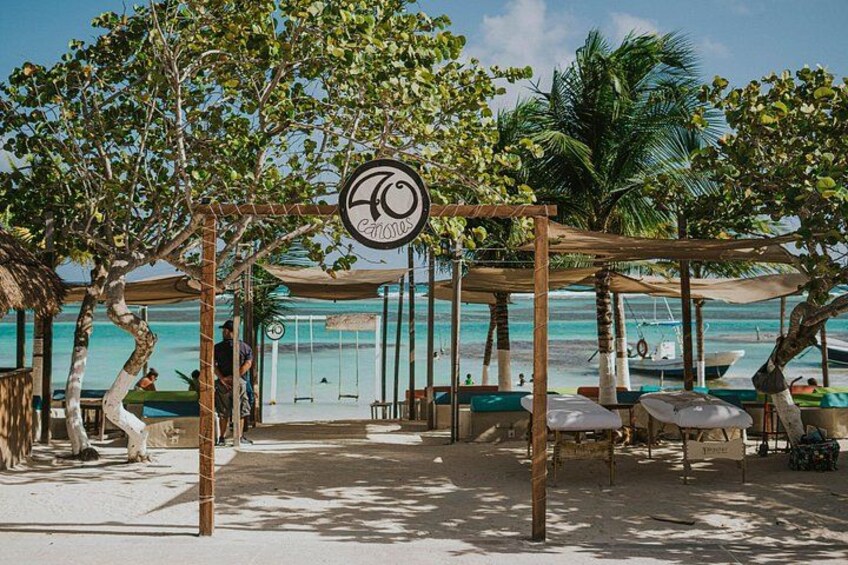 A beachside resort with wooden pergolas, lounge chairs, and a sign indicating a 70% occupancy rate. 1