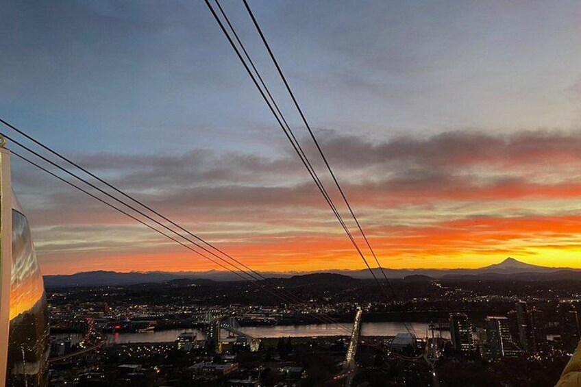 A cityscape at sunset with a mountain in the background. 4