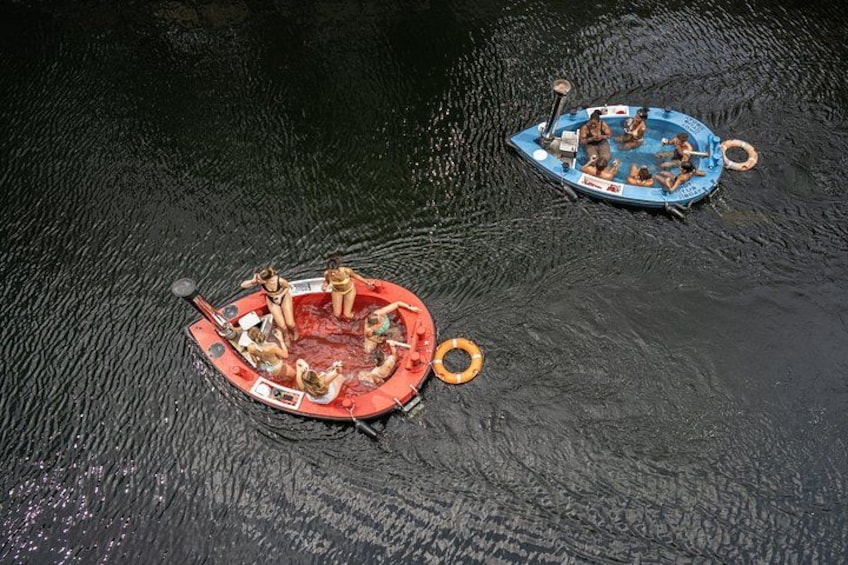 Two small boats with people on them on a body of water. 3